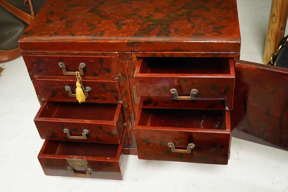 A Japanese floral lacquer table top cabinet, Taisho period, 36cm wide, the top panel is removable to form a twin pedestal cabinet